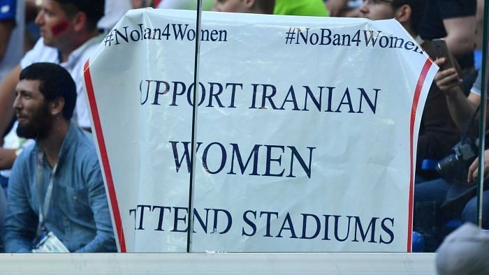 Supporter holds sign at World Cup 2018 match calling for women in stadiums.