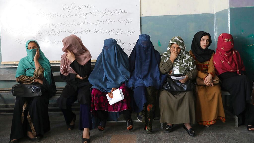 Afghan women wait for the a polling station to open in Kabul, Afghanistan on Saturday, 28 September 2019.
