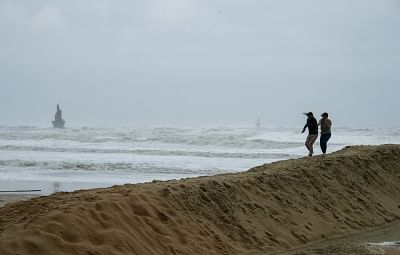 BUSAN, Oct. 6, 2018 (Xinhua) -- People walk against strong wind on the Haeundae Beach in Busan, South Korea, on Oct. 6, 2018. Typhoon Kong-rey landed in South Korea Saturday, bringing strong wind and heavy rain. (Xinhua/Wang Jingqiang/IANS)
