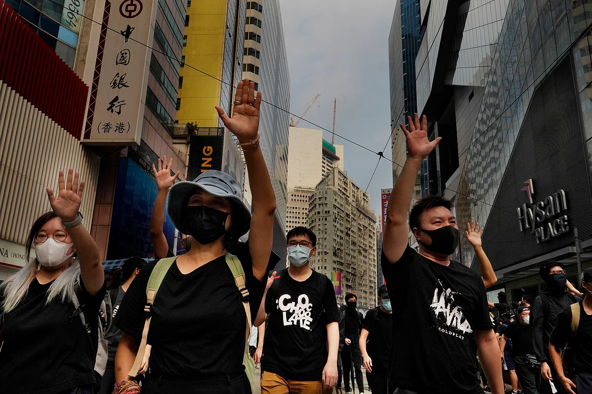 Protesters display opened palm with five fingers, signifying the five demands of protesters at a main street in Hong Kong,