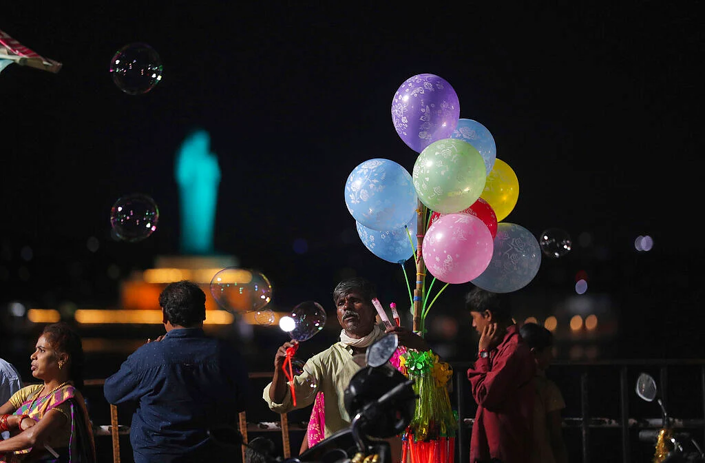 An Indian vendor sells balloons near the Hussain sagar lake in Hyderabad, Telangana. 