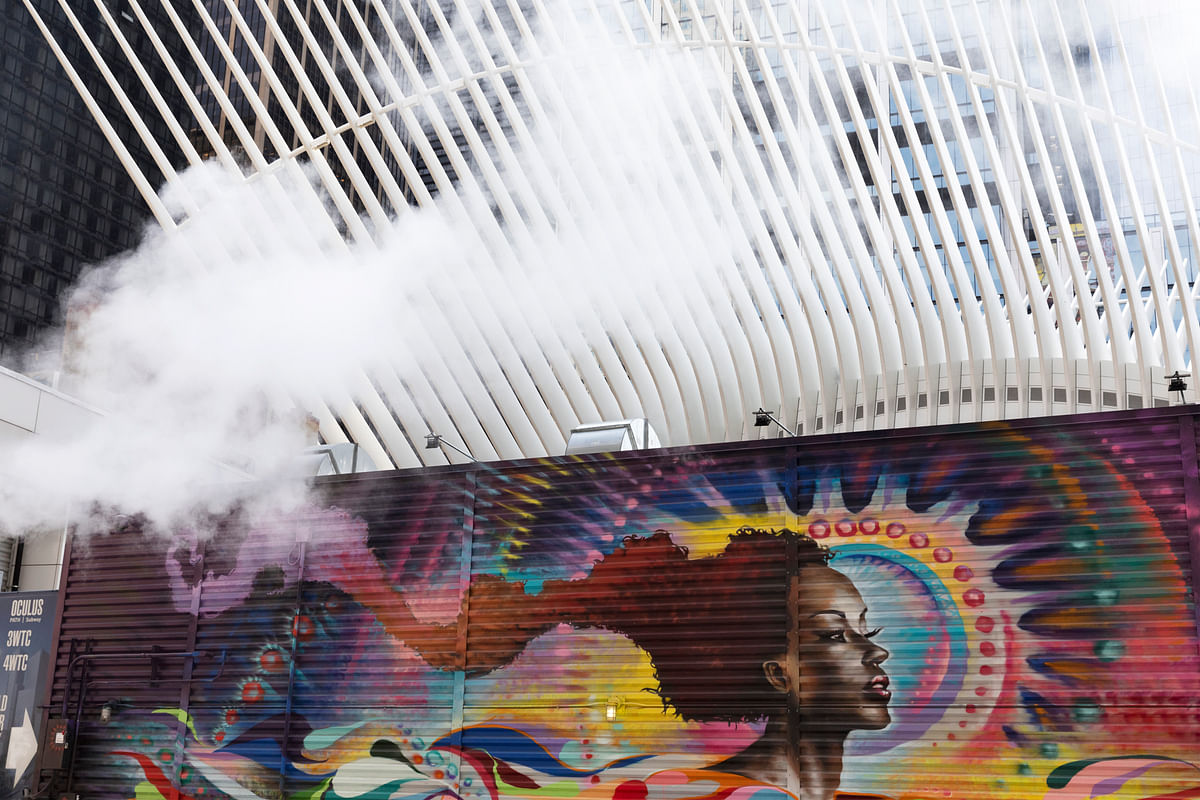 Steam blows by a mural placed at the future site of 2 World Trade Center, a planned commercial office tower on 9 September.