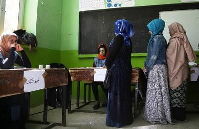 KABUL, Oct. 20, 2018 (Xinhua) -- Afghan voters wait to cast their ballots at a polling center during parliamentary elections in Kabul, Afghanistan, Oct. 20, 2018. Millions of Afghan voters cast their ballots on Saturday for long-delayed parliamentary elections in the militancy-plagued country amid reports of security threats and irregularities. (Xinhua/Rahmat Alizadah/IANS)
