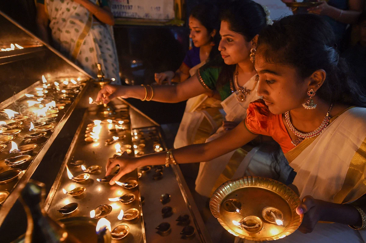 Women light lamps at a temple during Onam celebrations in Chennai, on Wednesday, 11 September. 