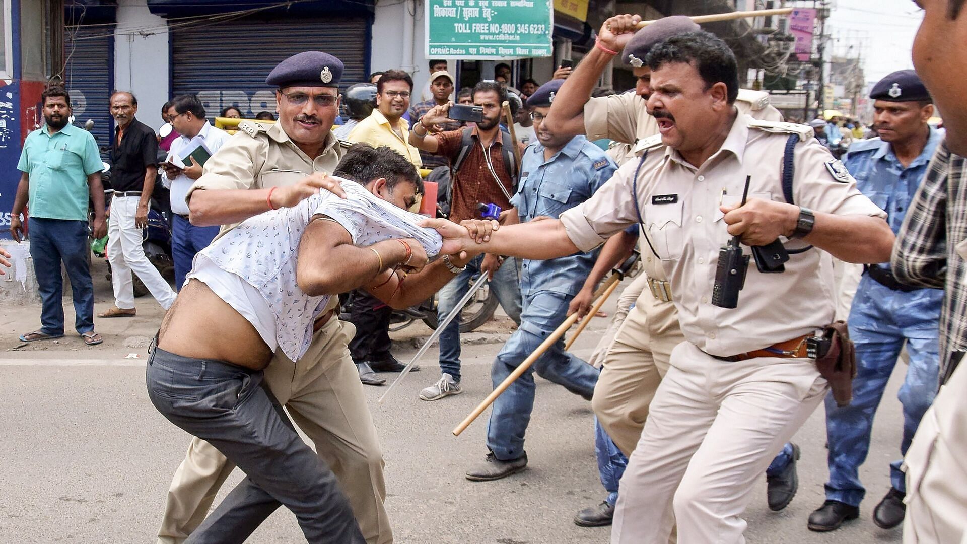 The police detains a protester during an agitation against the new Motor Vehicles (Amendment) Act in Patna, on 12 September.