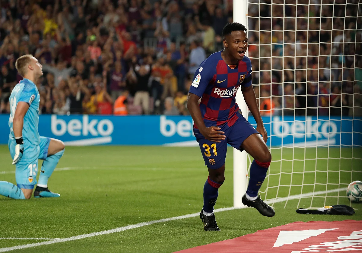 Barcelona’s Ansu Fati, right, celebrates after scoring the opening goal as Valencia’s goalkeeper Jasper Cillessen reacts during the Spanish La Liga soccer match between FC Barcelona and Valencia CF at the Camp Nou stadium in Barcelona.