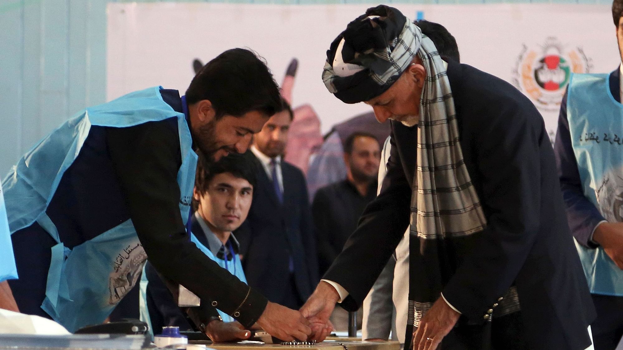 Afghan President Ashraf Ghani, right, inks his finger during the presidential election before he casts his vote at Amani high school, near the presidential palace in Kabul, Afghanistan, Saturday, 28 September, 2019.
