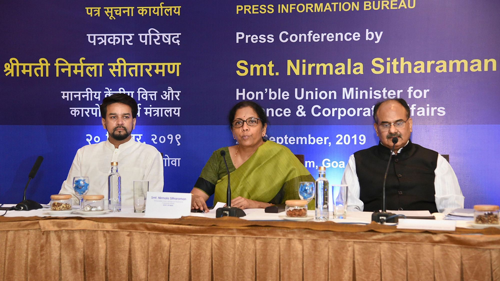 Finance Minister Nirmala Sitharaman (center) addresses a press conference to announce corporate tax relief for domestic companies.