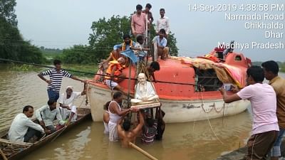 Villagers rescue the statute of Mahatma Gandhi in the flood affected Chikhalda village of Madhya Pradesh.