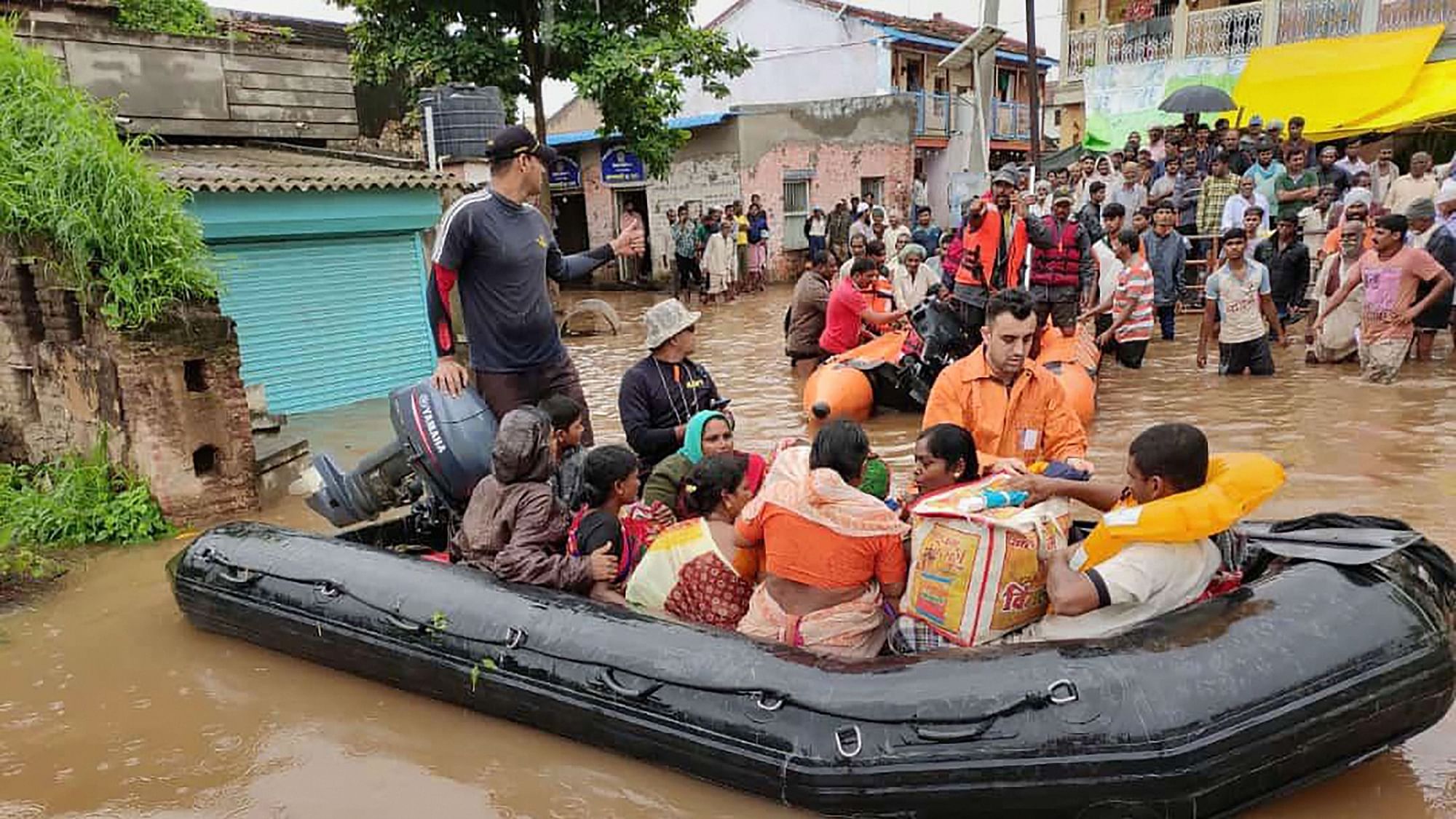 Indian Navy personnel rescue residents from flood-hit areas, in Sangli and Kolhapur districts of Maharashtra on 10 August.