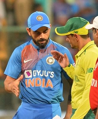 Bengaluru: Indian skipper Virat Kohli and South African skipper Quinton de Kock during the toss ahead of the 3rd T20I match between India and South Africa at M. Chinnaswamy Stadium in Bengaluru on Sep 22, 2019. (Photo: IANS)