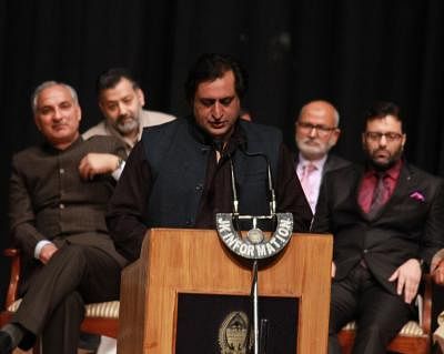 Jammu: Peoples Conference president Sajad Lone takes oath as a Jammu and Kashmir cabinet minister during a swearing-in ceremony organised at Jammu University on March 1, 2015. (Photo: IANS)