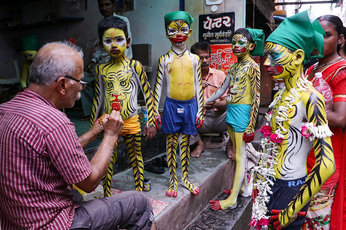 An artist paints young devotees ahead of Muharram festival, in Nagpur, Monday, 9 September. Muharram is the first month of the Islamic calendar and is considered as one of the sacred months of the year.