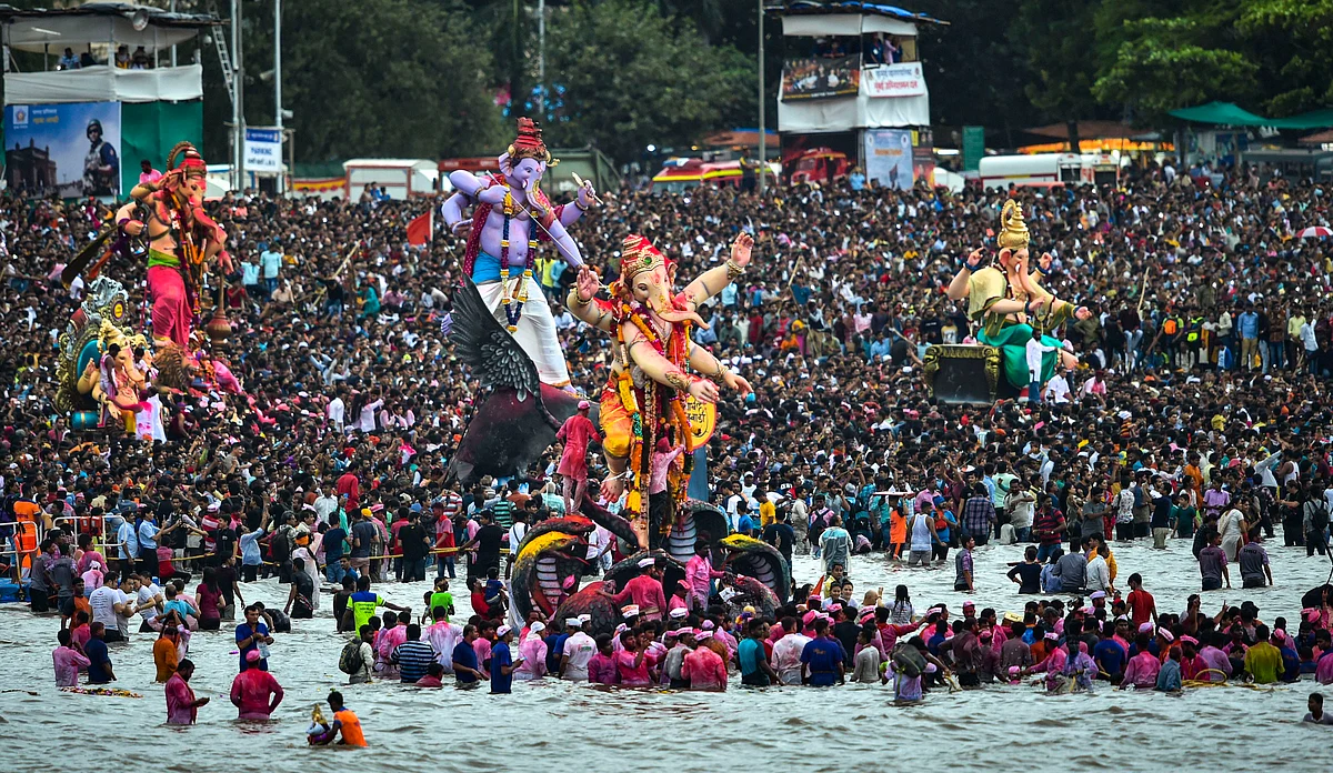 Devotees carry Ganesha idols for immersion to mark the end of Ganesh Utsav celebrations, at Girgaum Chowpatty in Mumbai on 12 September. 
