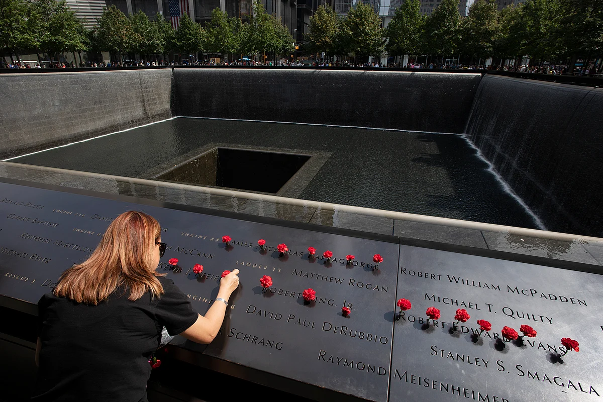 Norma Molina, of San Antonio, Texas, left flowers by the names of firefighters from Engine 33 at the September 11 Memorial on 9 September. 