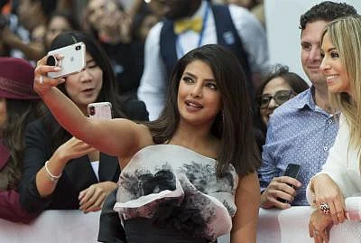 TORONTO, Sept. 13, 2019 (Xinhua) -- Actress Priyanka Chopra Jonas (C) takes selfies with fans before the world premiere of the film "The Sky Is Pink" at Roy Thomson Hall during the 2019 Toronto International Film Festival (TIFF) in Toronto, Canada, on Sept. 13, 2019. (Photo by Zou Zheng/Xinhua/IANS)