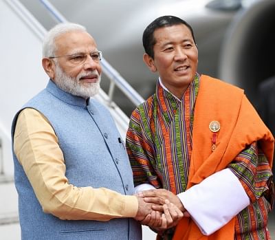 Paro: Bhutan Prime Minister Lotay Tshering receives Prime Minister Narendra Modi on his arrival at Paro in Bhutan on Aug 17, 2019. (Photo: IANS/PIB)