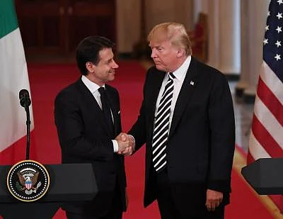 WASHINGTON, July 30, 2018 (Xinhua) -- U.S. President Donald Trump (R) shakes hands with Italian Prime Minister Giuseppe Conte during a joint press conference at the White House in Washington D.C., the United States, on July 30, 2018. U.S. President Donald Trump said during the press conference that he is ready to meet with Iranian President Hassan Rouhani without preconditions. (Xinhua/Liu Jie/IANS)