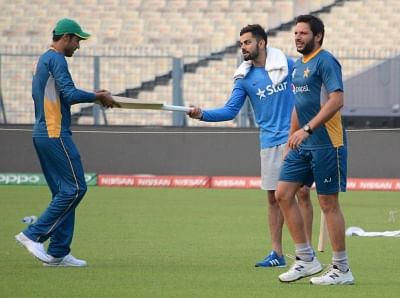 Kolkata: Indian cricketer Virat Kohli with Pakistan cricketers Shahid Afridi and Mohammad Amir during a practice session at Eden Gardens ahead of their ICC T20 World Cup match in Kolkata, on March 18, 2016. (Photo: Kuntal Chakrabarty/IANS)