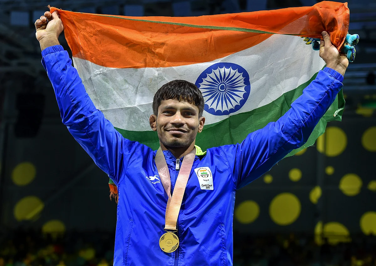 Gold medalist India’s Rahul Aware holds the tricolour after the medal ceremony of the men’s freestyle 57kg wrestling event at the Commonwealth Games 2018 in Gold Coast.