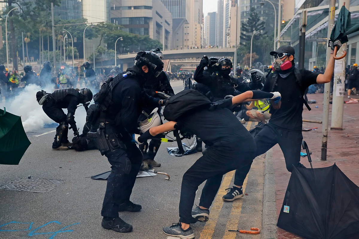 Protesters resisting arrest as police officers try to detain them. 