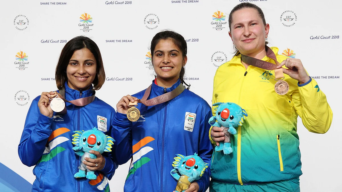 Gold medallist Manu Bhaker of India, silver medallist Heena Sidhu of India and bronze medalist Elena Galiabovitch pose with their medals after the 10m Air Pistol medal ceremony at the 2018 Commonwealth Games.