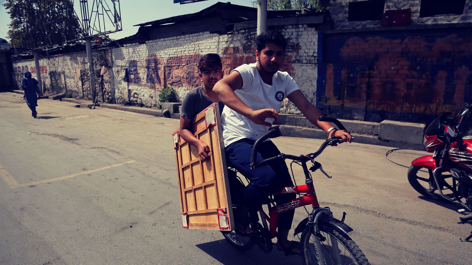 Kashmiri boys ride a bicycle carrying a carrom board in Srinagar, Indian controlled Kashmir, Thursday, Sept. 5, 2019. Image used for representational purposes.