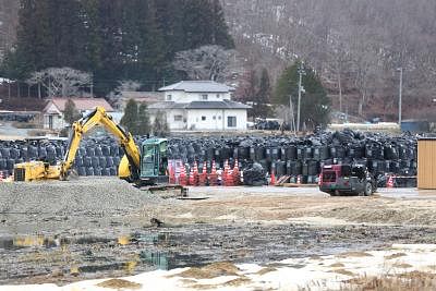 FUKUSHIMA, March 10, 2015 (Xinhua) -- Black bags containing buildup of contaminated wastes are seen in the town of Iitate, Fukushima Prefecture, Japan, March 7, 2015. The scenes from the towns and villages still abandoned four years after an earthquake triggered tsunami breached the defenses of the Fukushima Daiichi nuclear power plant, would make for the perfect backdrop for a post- apocalyptic Hollywood zombie movie, but the trouble would be that the levels of radiation in the area would be to