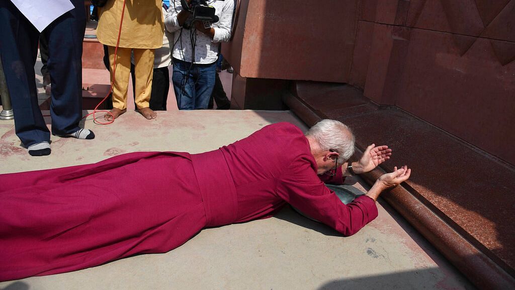 The Archbishop of Canterbury Reverend Justin Welby, prostrates as he pays respect at the Jallianwala Bagh memorial in Amritsar.