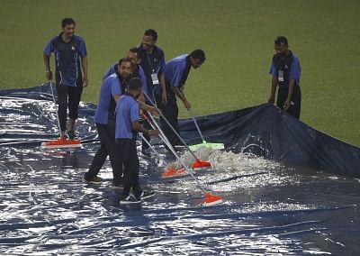 Dharamsala: Ground staff clearing water from the plastic sheets during rains ahead of the first T20I match between India and South Africa in Dharamsala on Sep 15, 2019. (Photo: Surjeet Yadav/IANS)