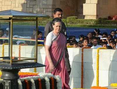 Congress president Sonia Gandhi paying homage to Mahatma Gandhi on his 144th birth anniversary at Rajghat, New Delhi on Oct. 2, 2013. (Photo: IANS)