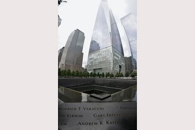 A view of the 9/11 memorial with a view of the new World Trade Center building behind it. Some of the names of the victims of the the attack by terrorists on September 11, 2001, are seen in the foreground. A commemoration ceremony is held there every year on September 11. (Photo: Jvangiel/WikiMedia)