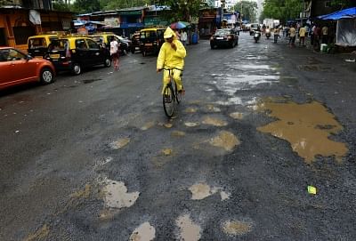Mumbai: Potholes appear in Mumbai roads after heavy rains lashed the city over past few days on July 11, 2018. (Photo: IANS)