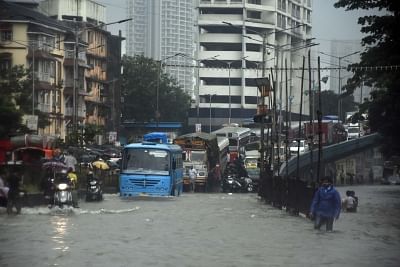 Mumbai: Vehicles wade through a water-logged street after heavy rains, in Mumbai on Sep 4, 2019. (Photo: IANS)