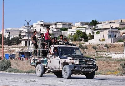 IDLIB (SYRIA), Aug. 24, 2019 (Xinhua) -- Syrian soldiers are seen in the town of Khan Shaykhun in the southern countryside of Idlib province, Syria, on Aug. 24, 2019. The Syrian army on Friday fully secured the entire northern countryside of the central province of Hama for the first time since 2012, the state media reported. (Photo by Ammar Safarjalani/Xinhua/IANS)