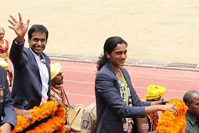 Hyderabad: Indian Badminton team coach Pullela Gopichand and Indian badminton player P.V. Sindhu during a programme organised to felicitate her in Hyderabad on Aug 22, 2016. Sindhu won silver medal in Rio 2016 Olympics. (Photo: IANS)