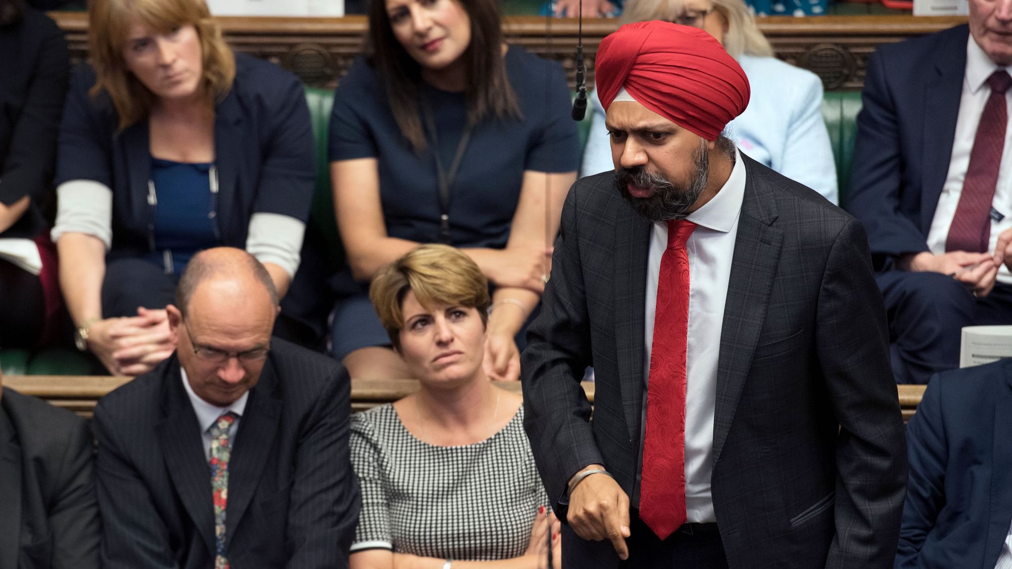 In this handout photo provided by the House of Commons, Labour MP Tanmanjeet Singh Dhesi, was applauded after challenging Prime Minister Boris Johnson to apologize for comparing Muslim women who wear face-covering veils to “letter boxes.”