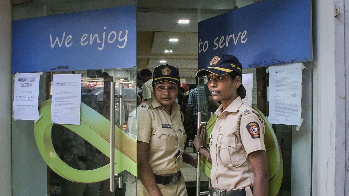 Police personnel stand guard outside PMC Bank in Mumbai