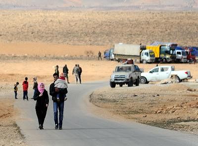 DAMASCUS, Dec. 25, 2018 (Xinhua) -- Syrian refugees return from Lebanon at the Zamarani border crossing north of Damascus, Syria, on Dec. 24, 2018. Over 1,000 Syrian refugees returned Monday to their homeland from various areas in Lebanon including Tripoli, Aarsal, Tyre and Nabatieh. (Xinhua/Ammar Safarjalani/IANS)