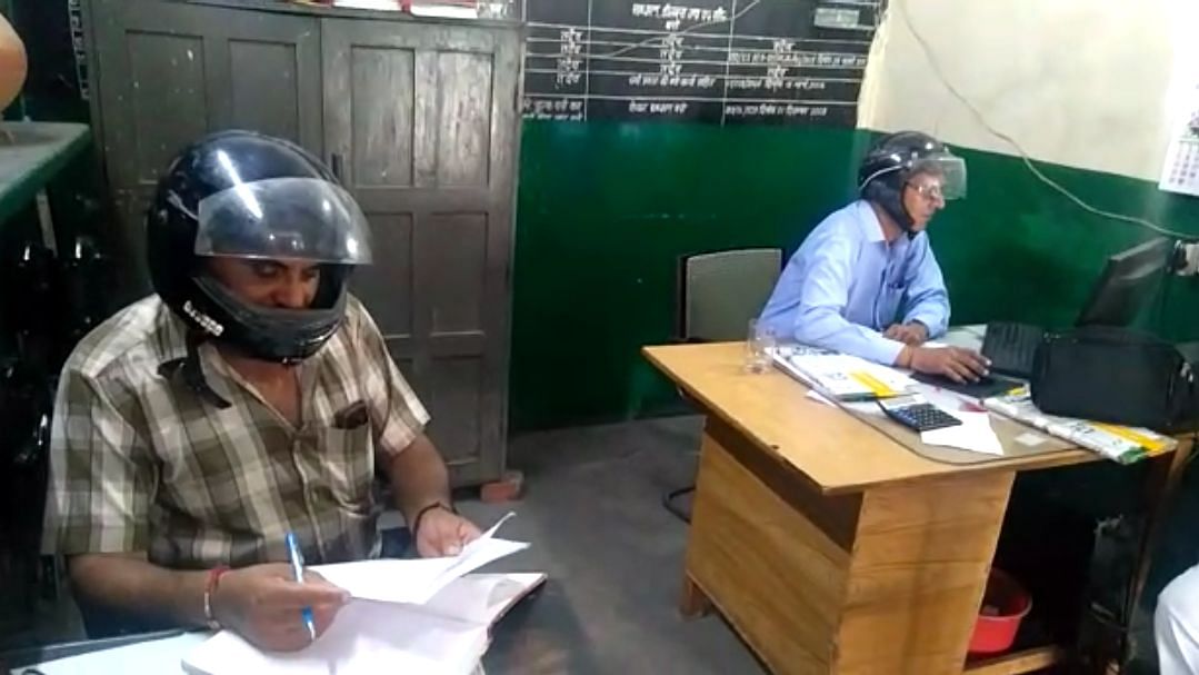 Employees at the Roadways office in Roorkee are forced to wear helmets as the ceiling crust keeps chipping off and falling