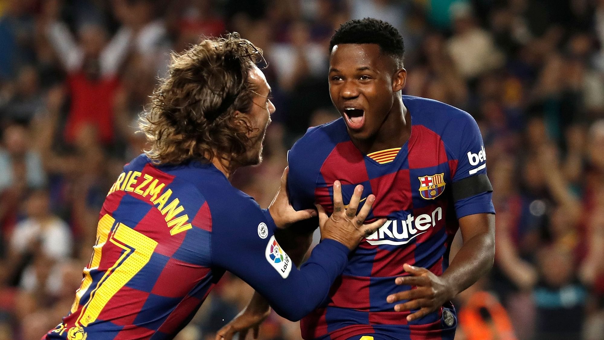 Barcelona’s Ansu Fati, right, celebrates with teammate Barcelona’s Antoine Griezmann after scoring the opening goal during the Spanish La Liga soccer match between FC Barcelona and Valencia CF at the Camp Nou stadium in Barcelona.