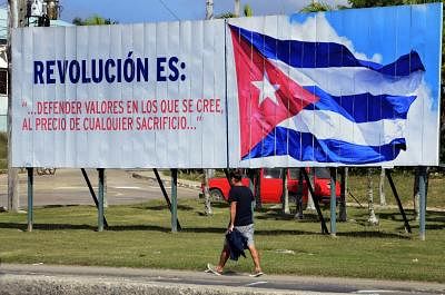 HAVANA, Jan. 2, 2019 (Xinhua) -- A man walks past a billboard on a street in Havana, Cuba, Dec. 29, 2018. TO GO WITH Feature: Cuba marks 60th anniversary of revolution, continuing on socialist path (Xinhua/Joaquin Hernandez/IANS)