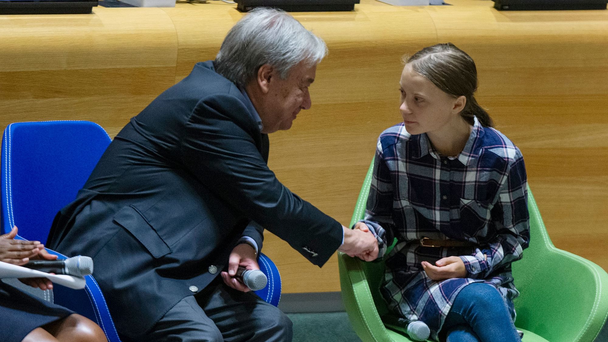 Swedish environmental activist Greta Thunberg, right, shakes hands with UN Secretary-General Antonio Guterres, during the Youth Climate Summit at United Nations headquarters.
