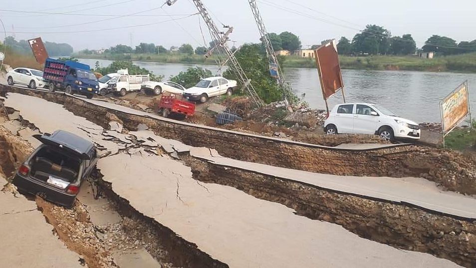 Heavily damaged roads with many vehicles overturned in Pakistan.