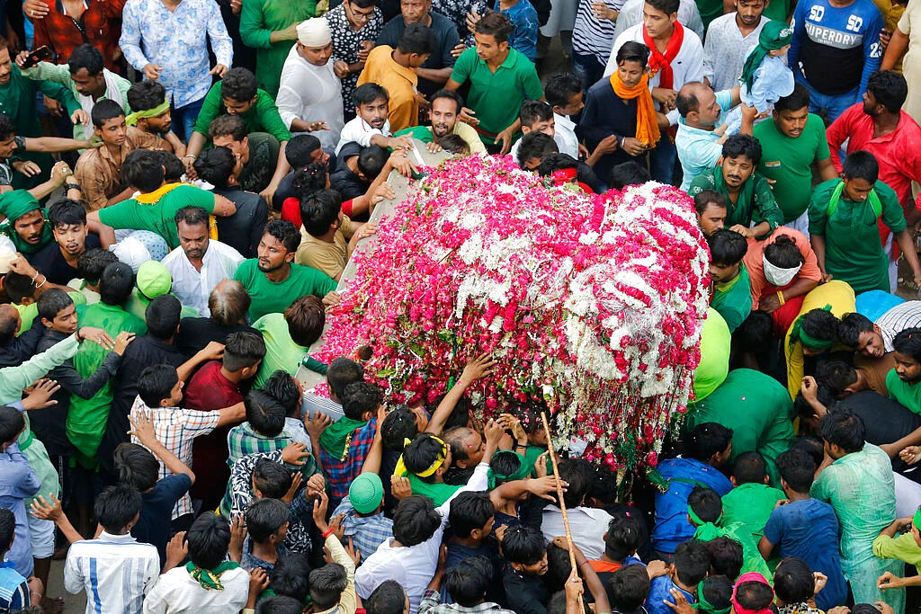 Indian Shiite Muslims take out a tableau in a religious procession to mark the Muslim festival, Prayagraj, India on Tuesday, 10 September. Ashoura, the tenth day of the lunar Islamic month of Muharram, is marked by Shiite believers as the day that Imam Hussein, the grandson of prophet Muhammad and one of their most revered saints, was killed in the battle of Karbala in the year 680 AD.