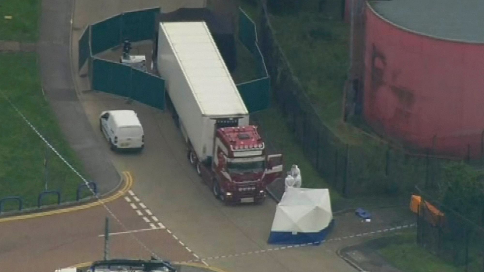 Police forensic officers attend the scene after a truck was found to contain a large number of dead bodies, in South England.