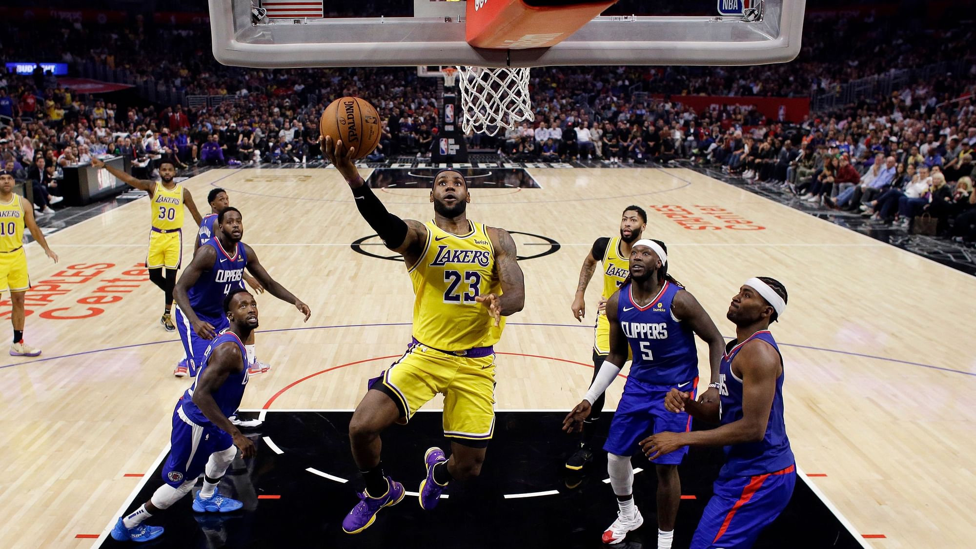 Los Angeles Lakers’ LeBron James, center, drives to the basket against the Los Angeles Clippers during the second half of an NBA basketball game Tuesday, Oct. 22, 2019, in Los Angeles.