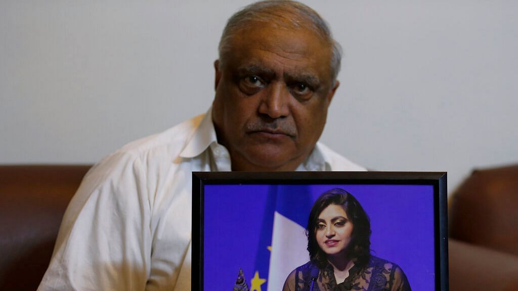 Professor Mohammad Ismail, father of a Pakistani human rights activist Gulalai Ismail, holds a picture of his daughter as he poses for a photo, in his home in Islamabad, Pakistan, on 17 October 2019.&nbsp;