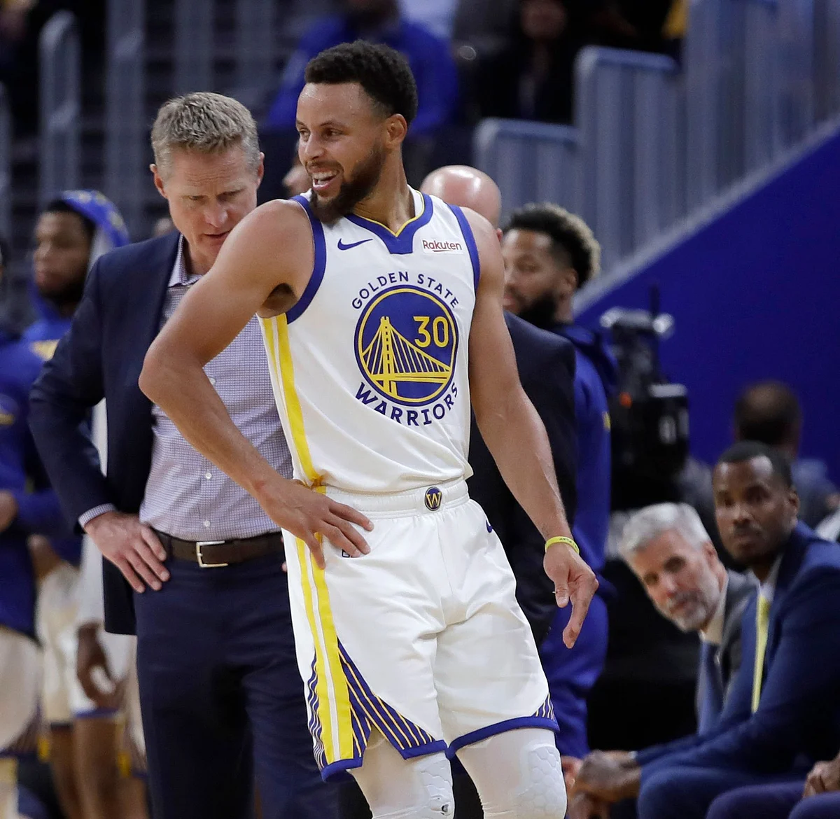 Golden State Warriors coach Steve Kerr, left, observes Stephen Curry (30) after Phoenix Suns’ Aron Baynes fell on him during the second half of an NBA basketball game Wednesday, Oct. 30, 2019, in San Francisco. Curry left the game with injury. 