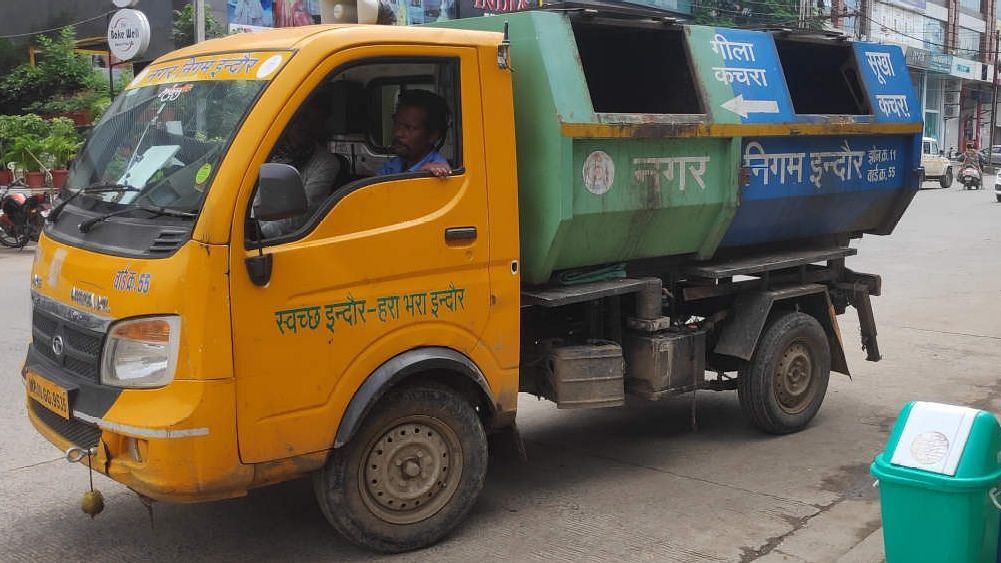 A garbage collection van with separate compartments for wet, dry and hazardous waste picks up segregated household trash in Indore, 6 September 2019.